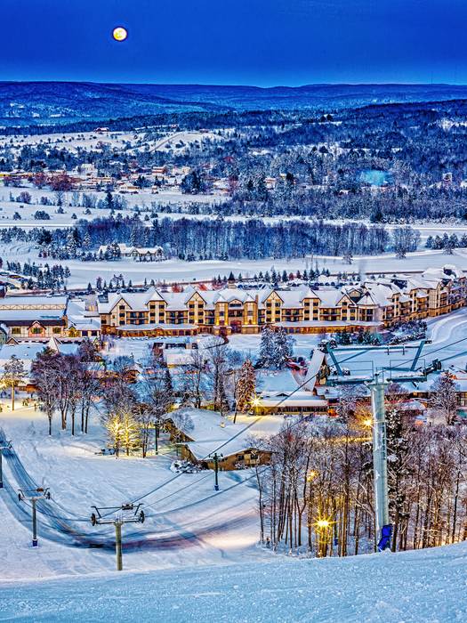 View of Mountain Grand Lodge and Spa in the winter from the top of the ski hill.
