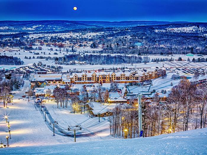 View of Mountain Grand Lodge and Spa in the winter from the top of the ski hill.