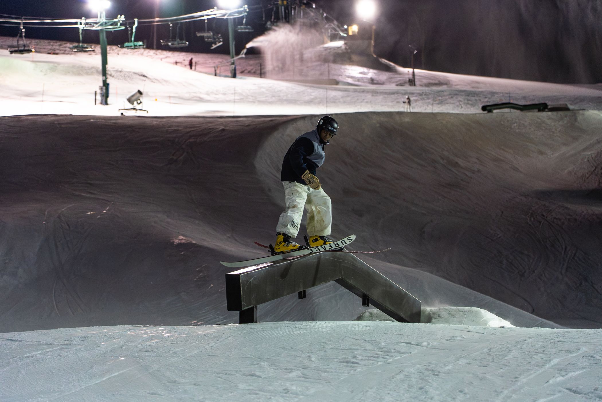 skier hitting rail at night