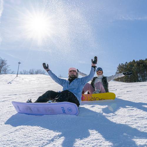 girls snowboarding in spring