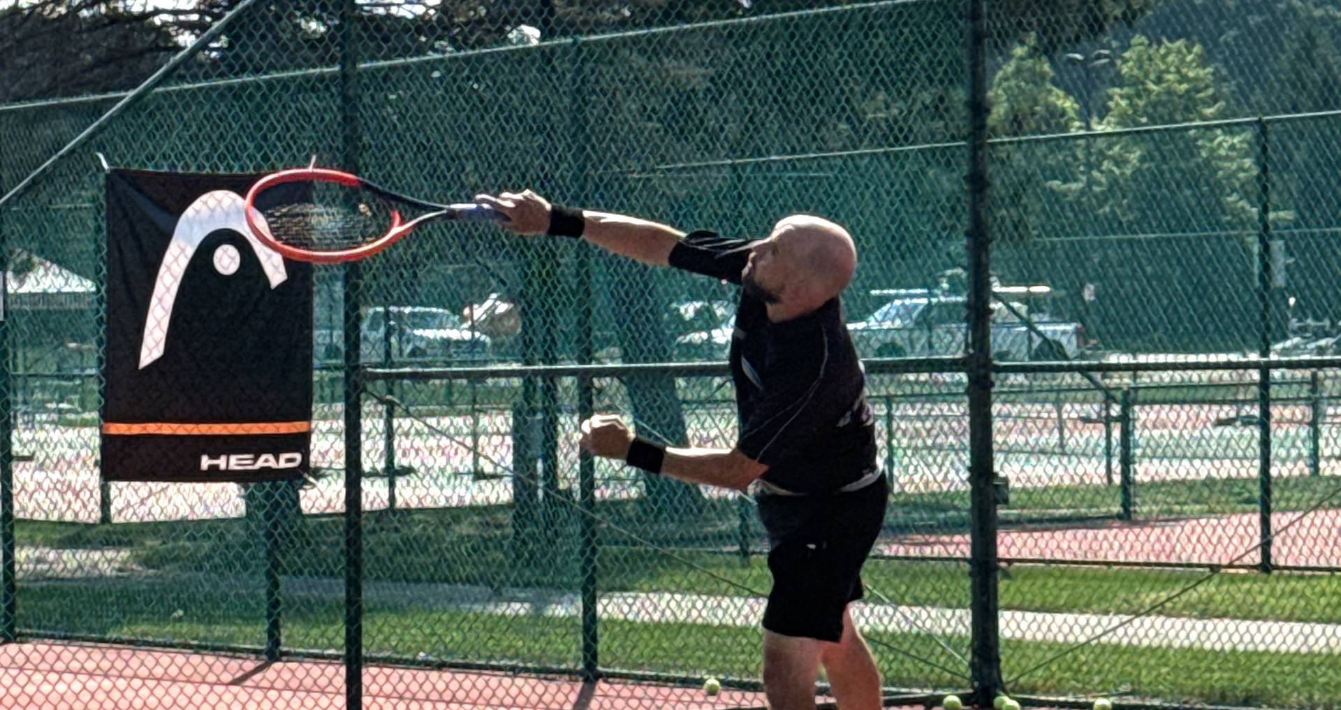 guy serving the tennis ball