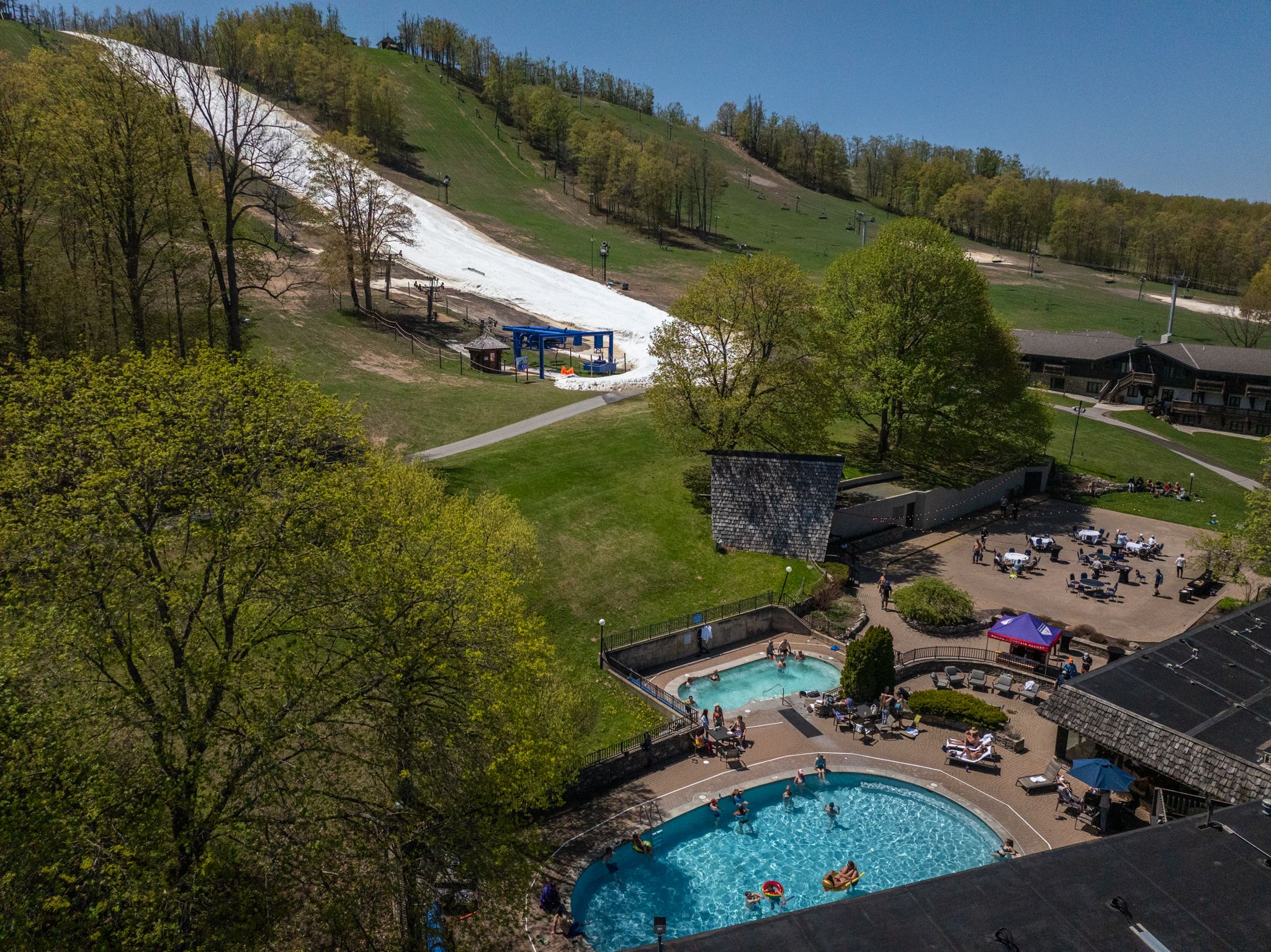 People enjoying the outdoor pool with Victor Glacier in the background