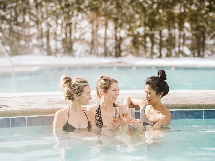 Ladies in hot tub with champagne