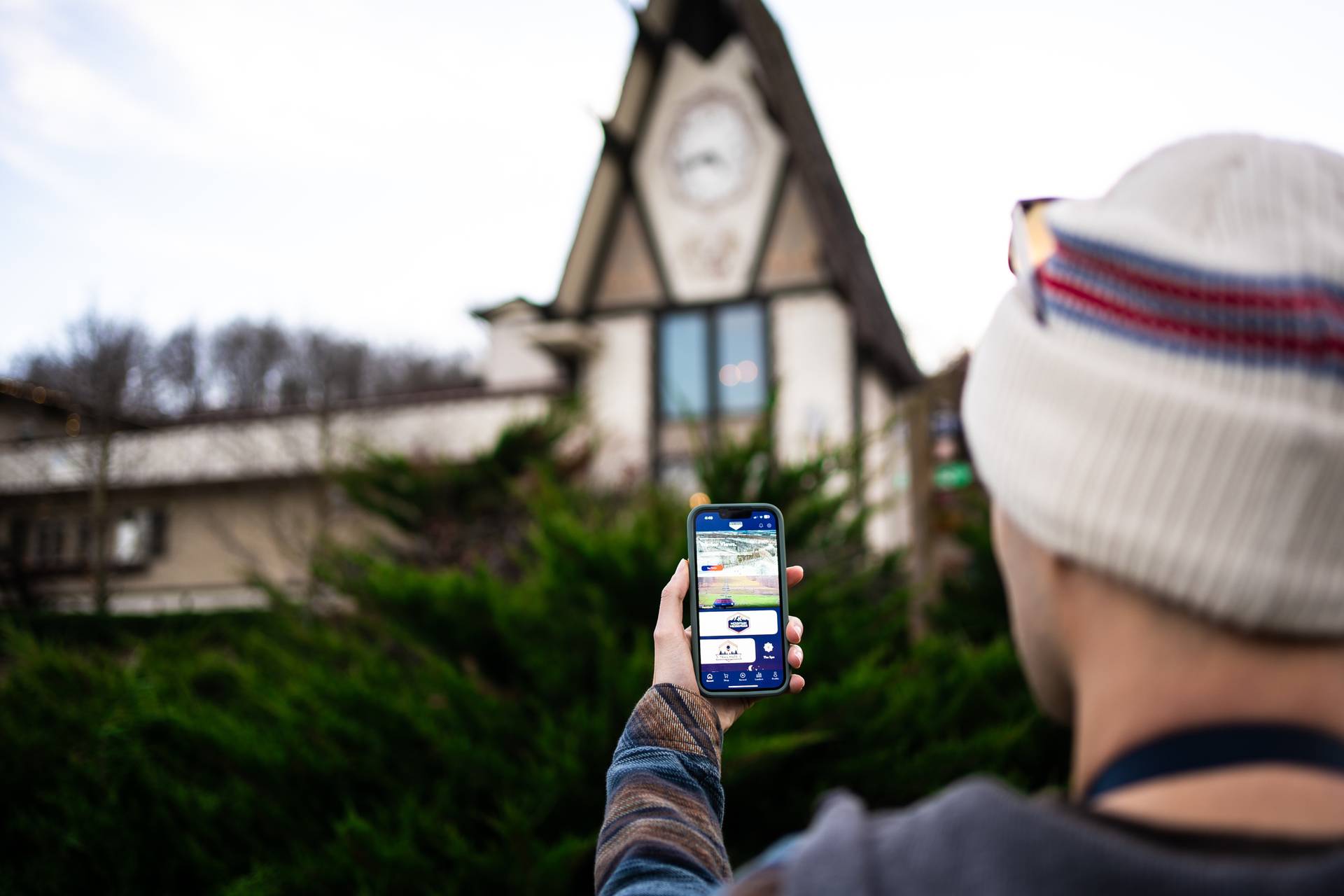 someone holding phone up with Boyne Mountain app displayed on screen