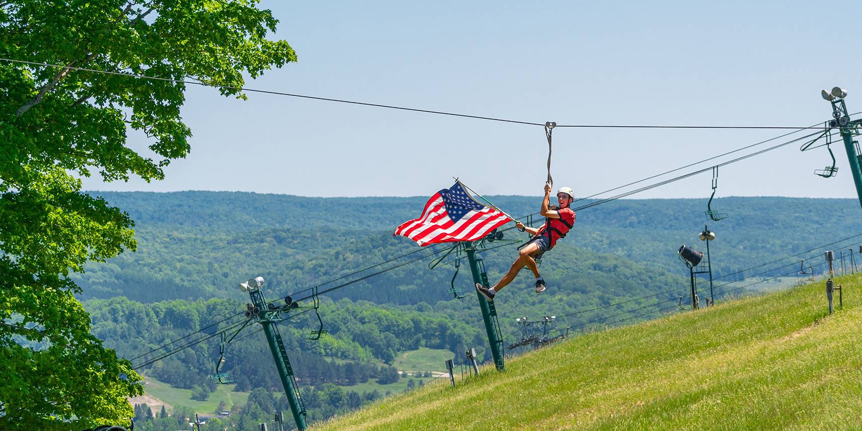 Ziplining with American Flag at Boyne Mountain Resort