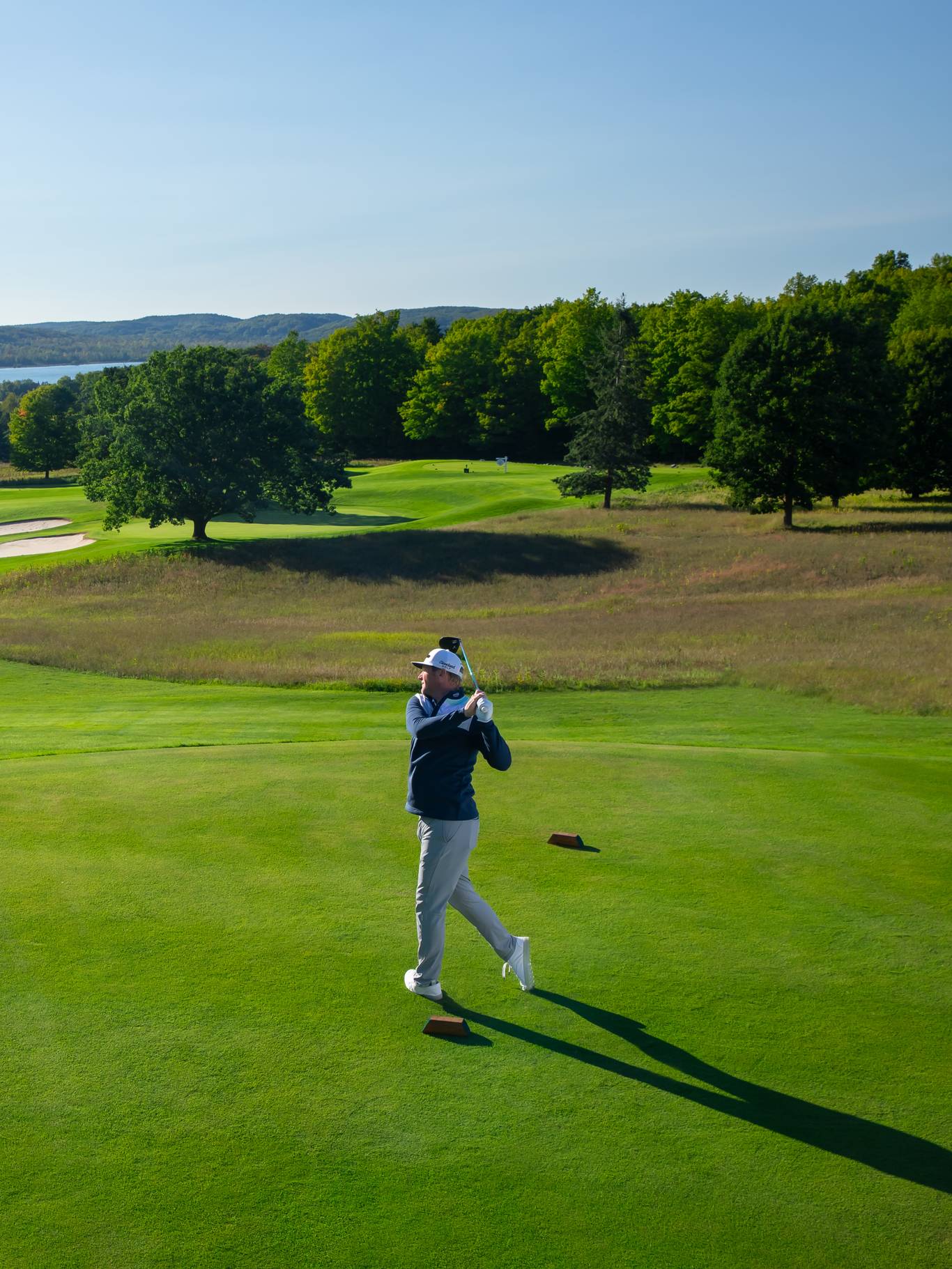 Golfer teeing off on the Alpine