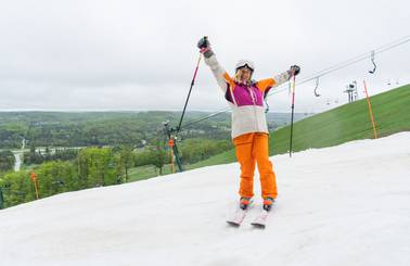 Skier holding up poles on Victor Glacier