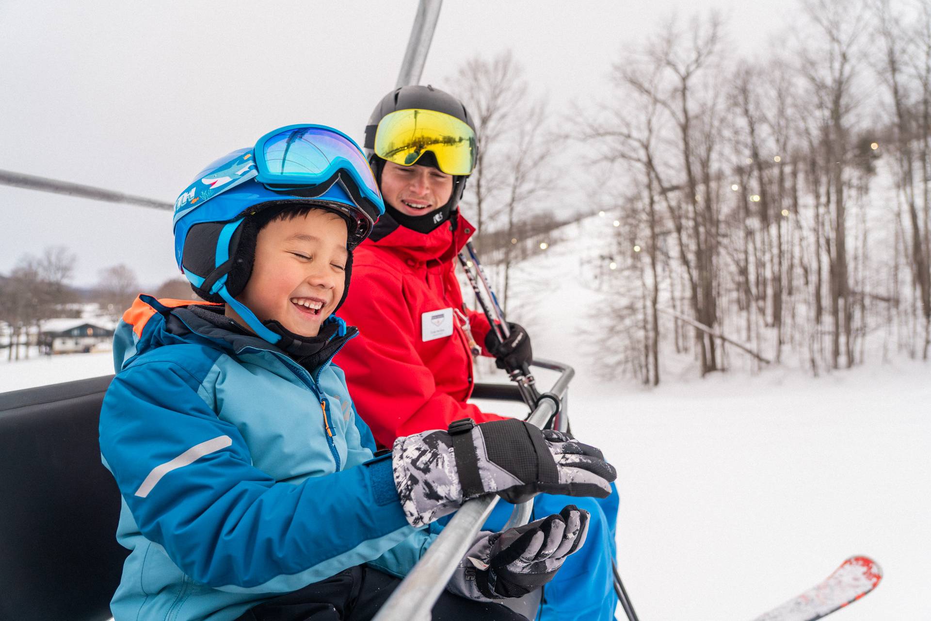 Instructor and child riding chairlift.