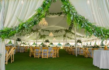 deer lake wedding tent setup with flowers