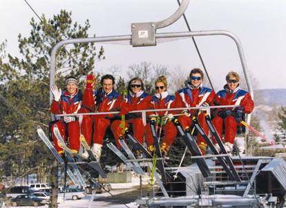 Ski instructors riding Boyne Mountains six place high speed chairlift.