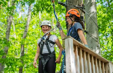 zipline guide helping guest