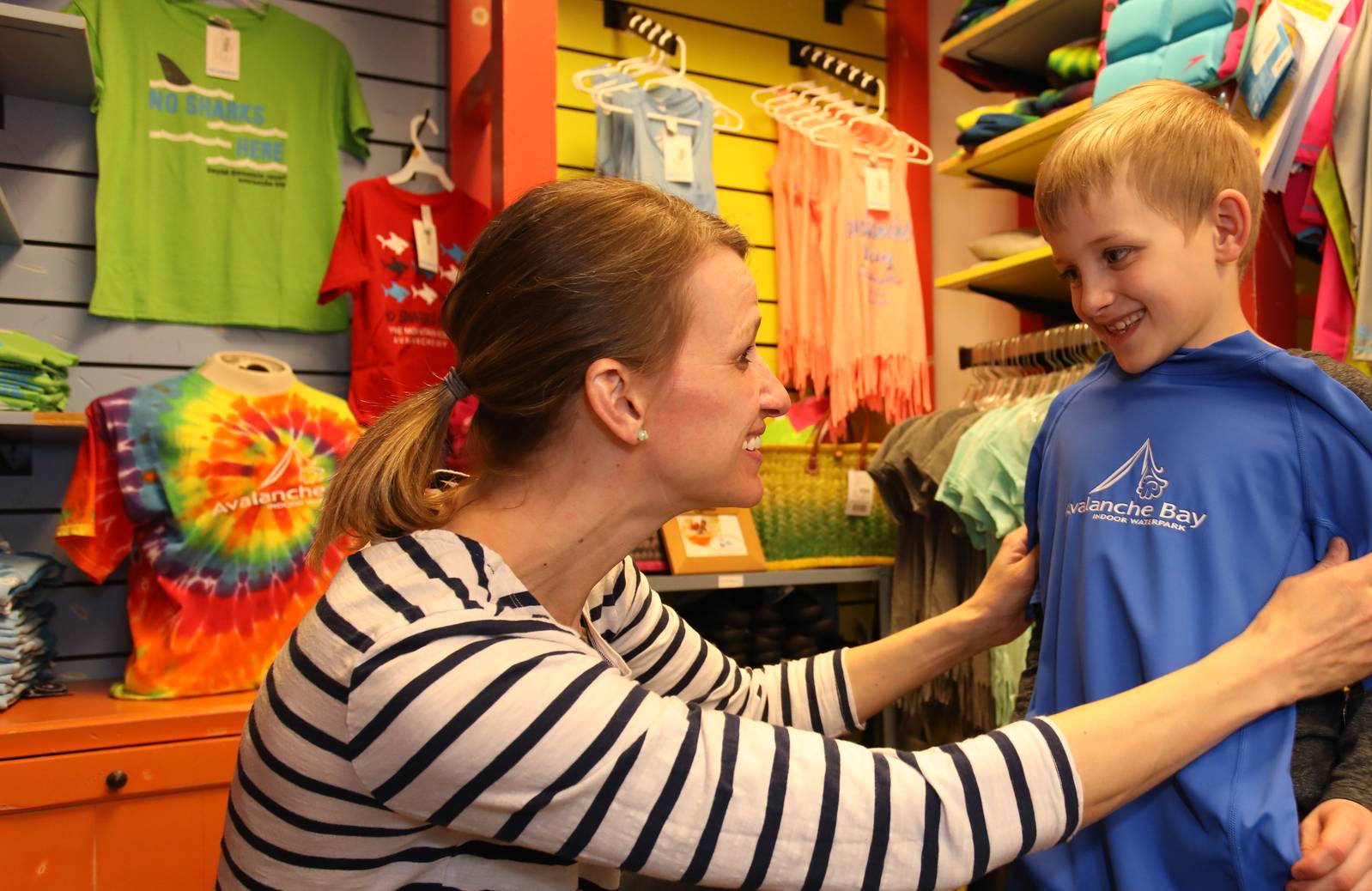 mom and son trying on a Avalanche Bay tshirt