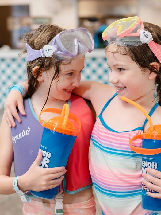 Two young girls with drinks