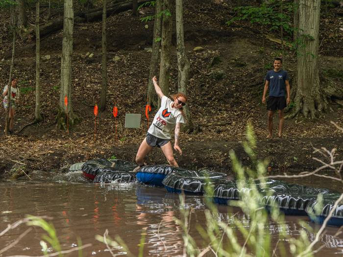 Girl racer walking acorss tube obstacle