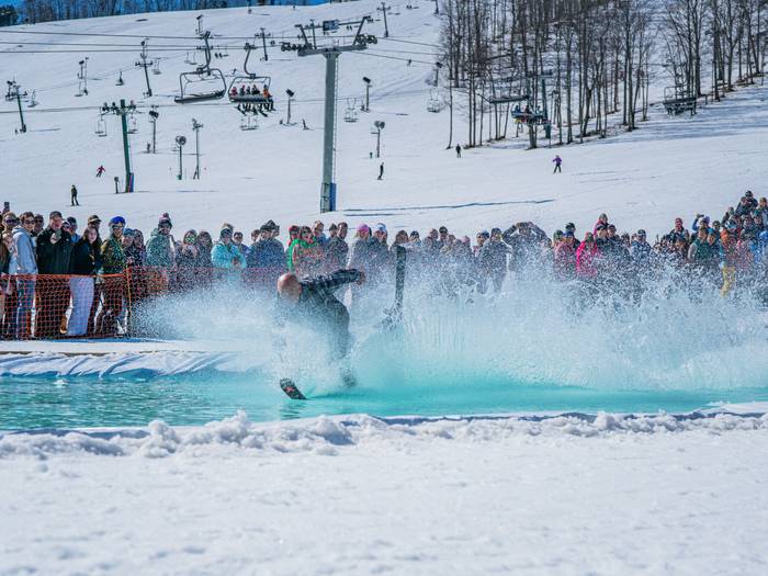Man wiping out riding the slush cup pool