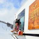 Guy looking out from the Happy's Taco Truck giving thumbs up