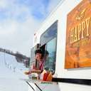 Guy looking out from the Happy's Taco Truck giving thumbs up