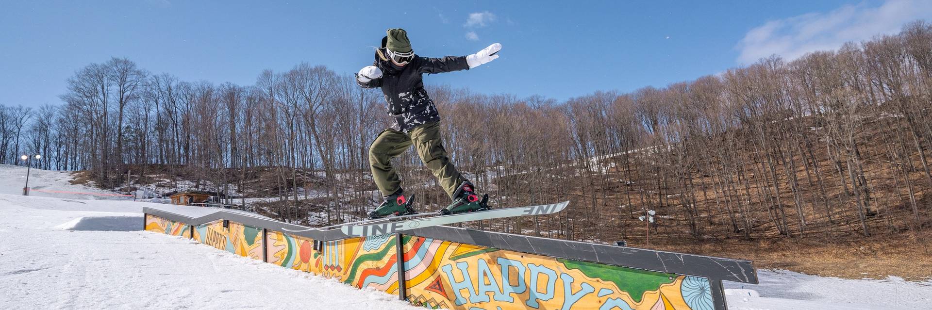 Girl snowboarding on rails at the terrian park