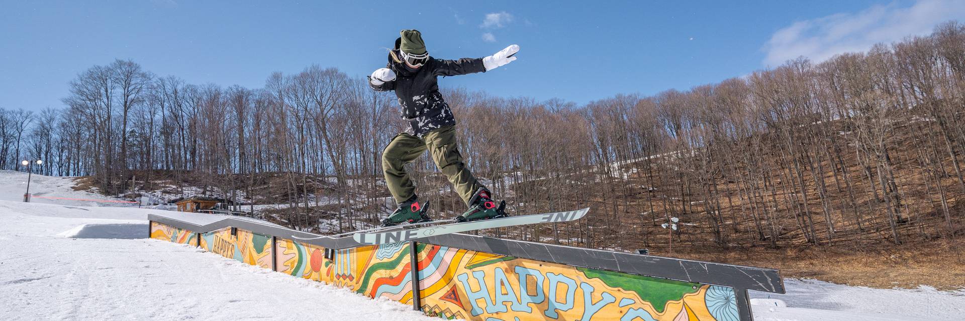 Girl snowboarding on rails at the terrian park