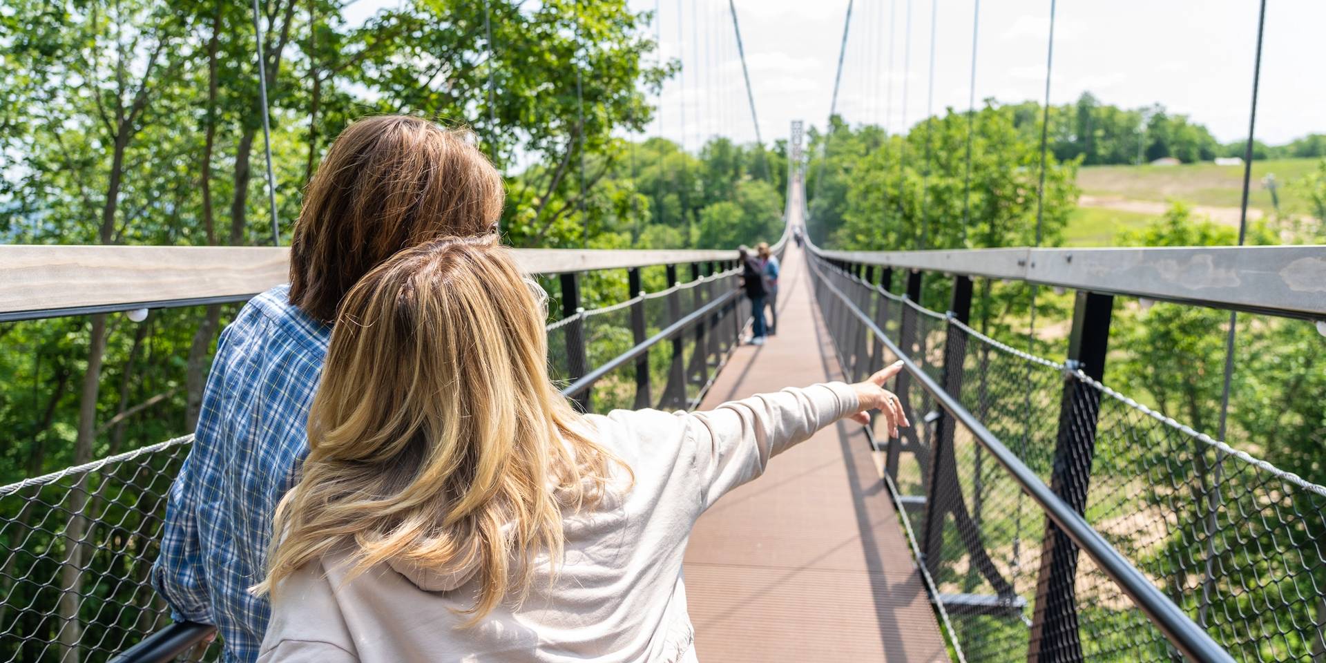 two women walking across skybridge michigan