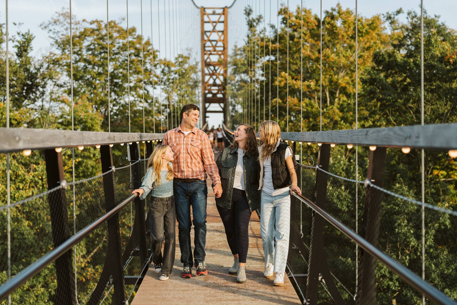 family walking across skybridge