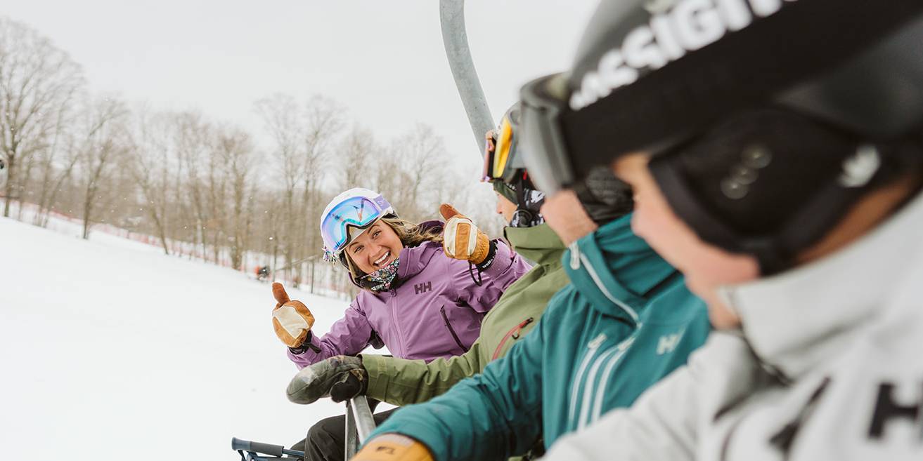 Skiers riding chairlift