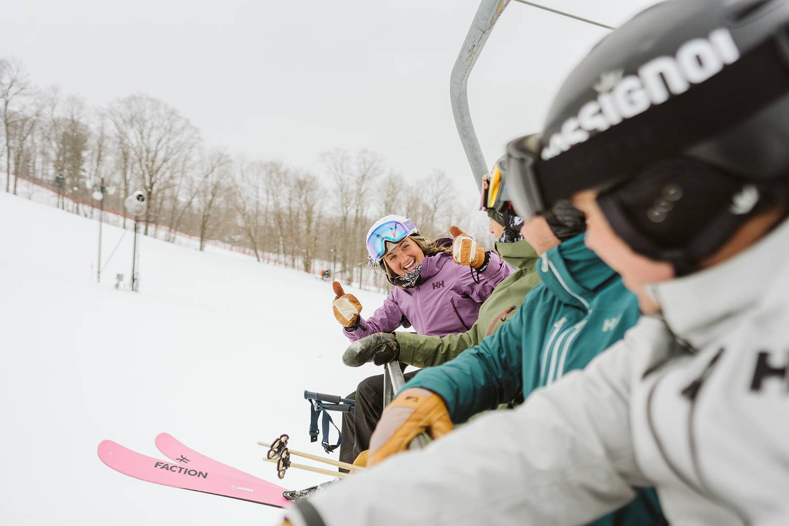 friends smiling on chairlift