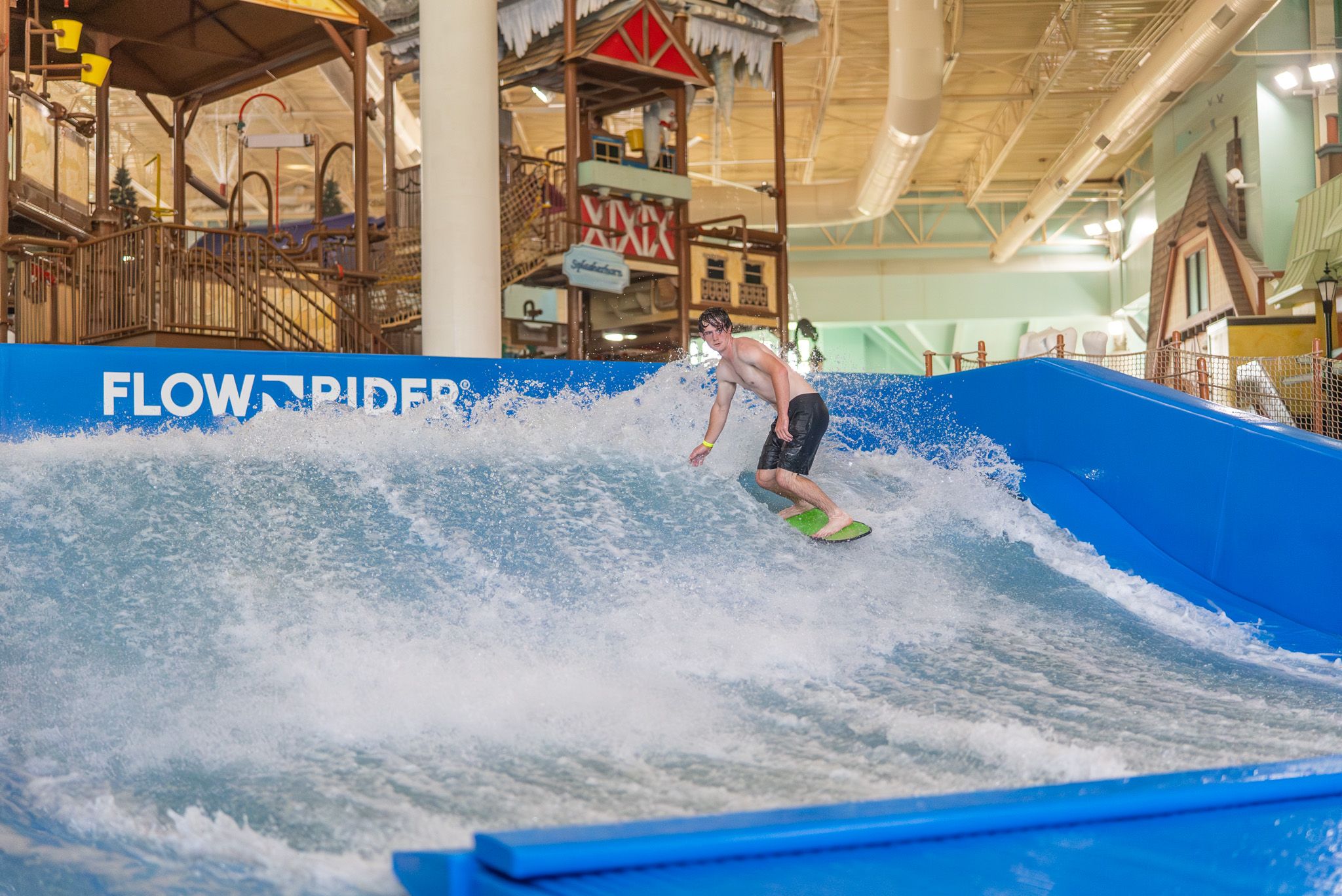 Person riding Flow Rider at Avalanche Bay Indoor Waterpark