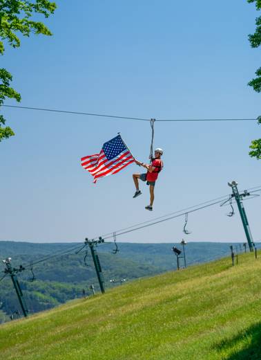 ziplining with flag