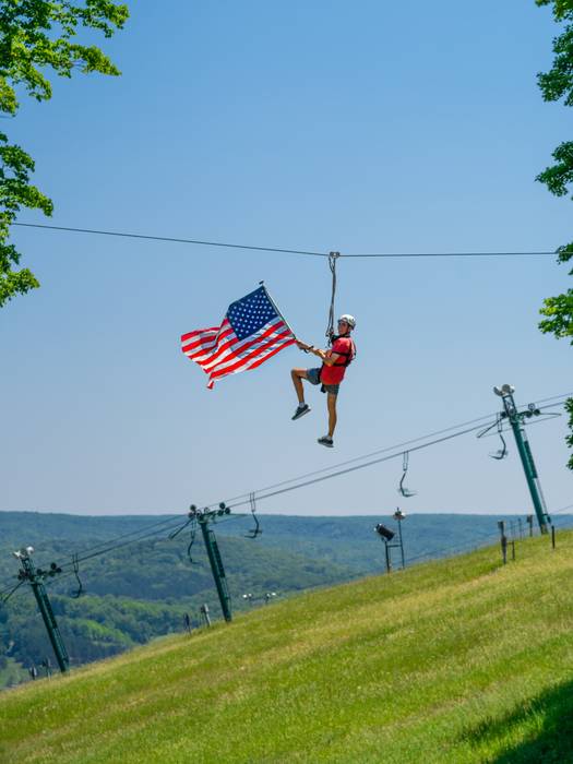 ziplining with flag