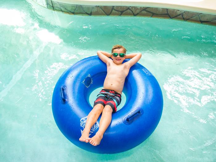 Boy floating in tube in Lazy River