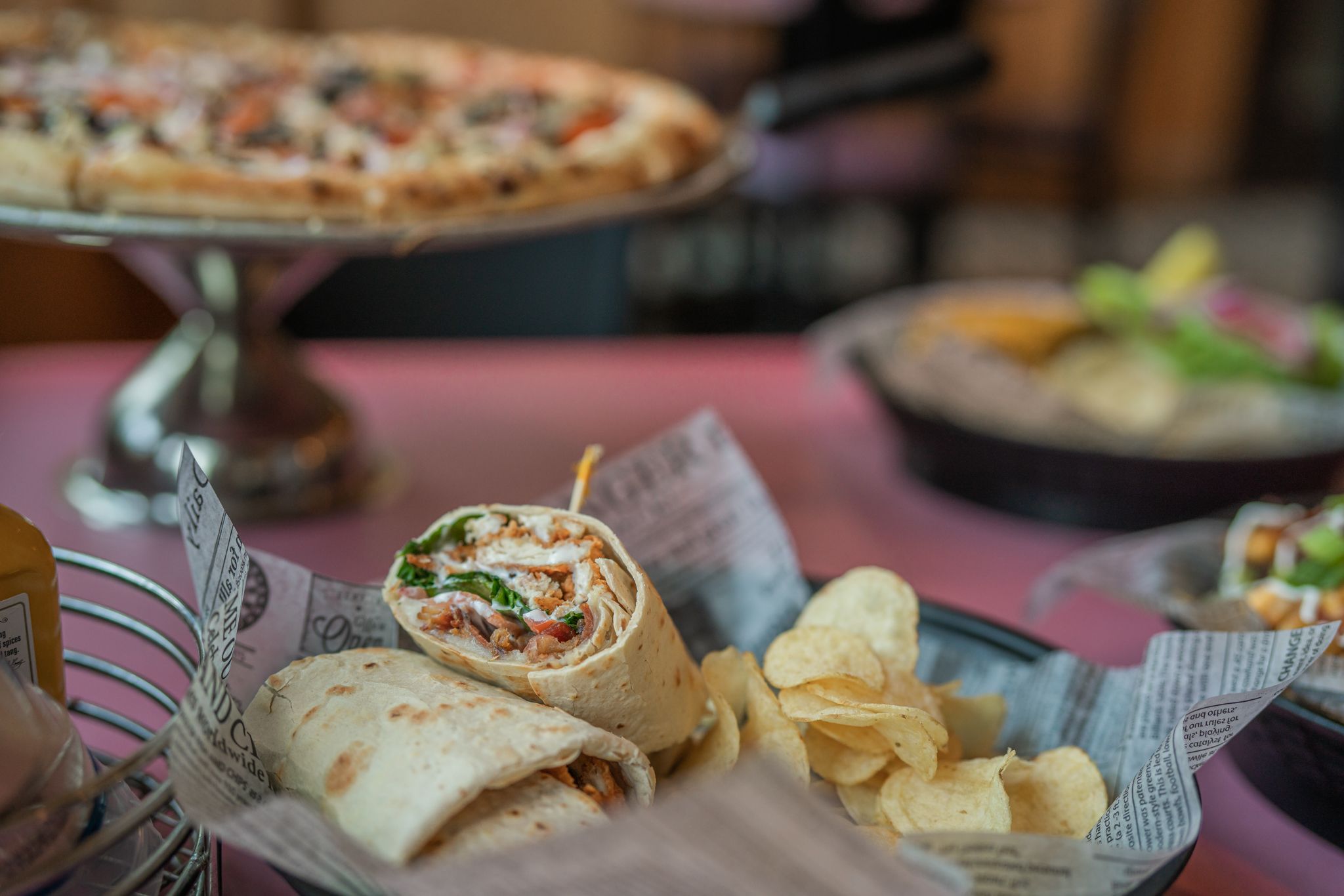 Spread of food at Apres Ski Pub showing a wrap and pizza.