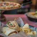 Spread of food at Apres Ski Pub showing a wrap and pizza.