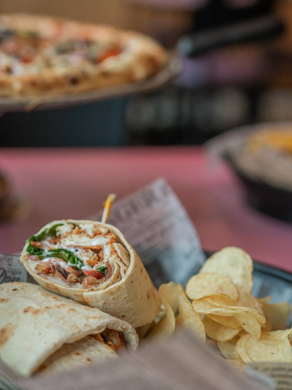 Spread of food at Apres Ski Pub showing a wrap and pizza.