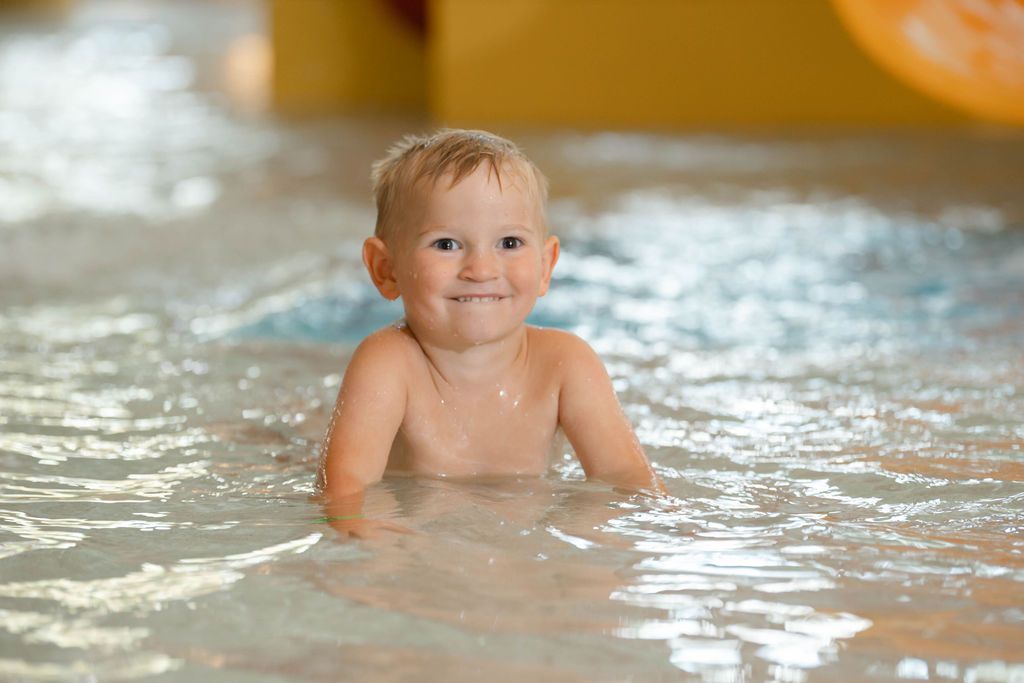 little boy in the pool at the waterpark