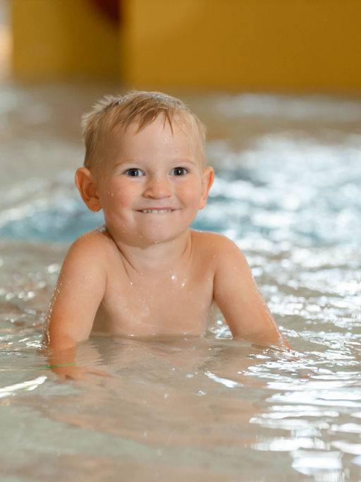 little boy in the pool at the waterpark