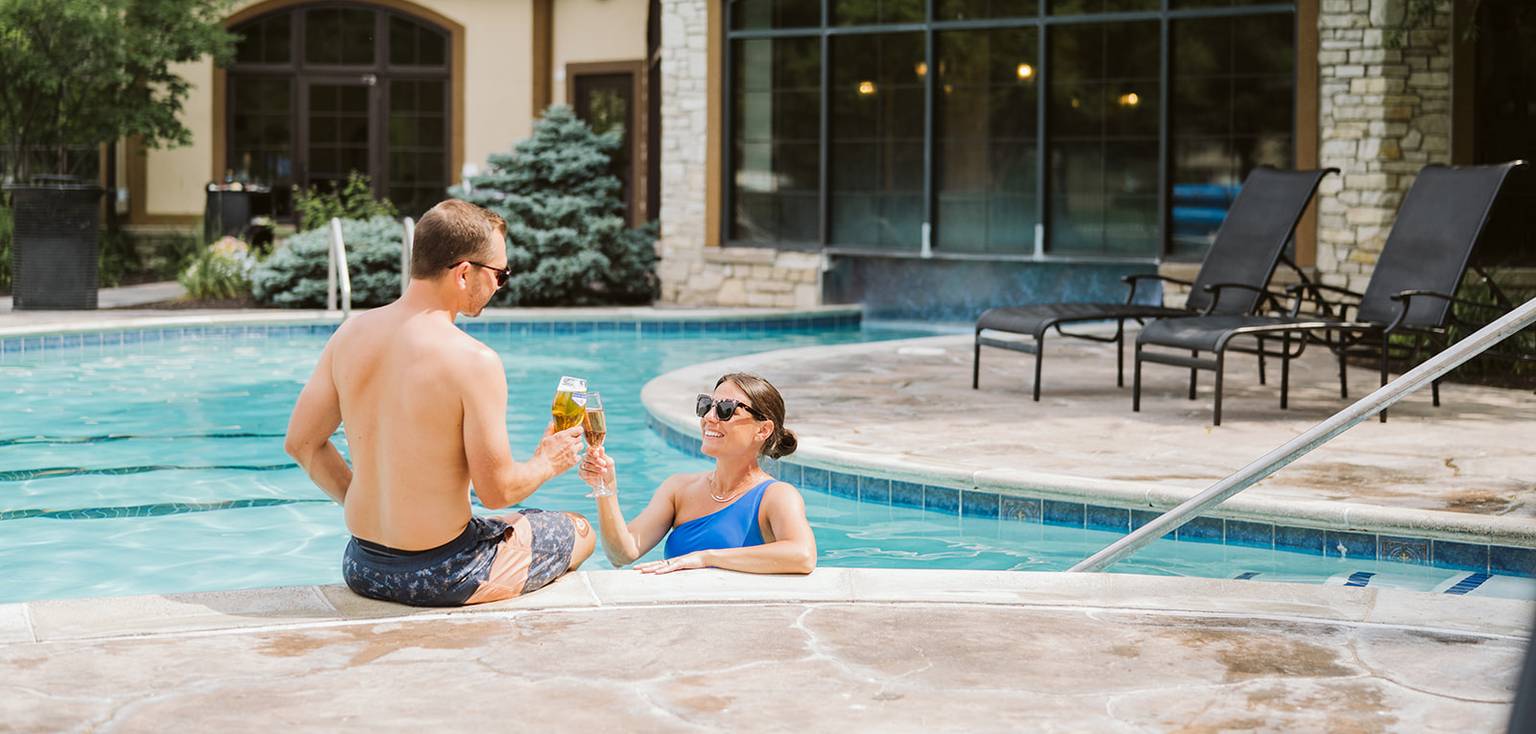 Couple enjoying drinks at the pool.