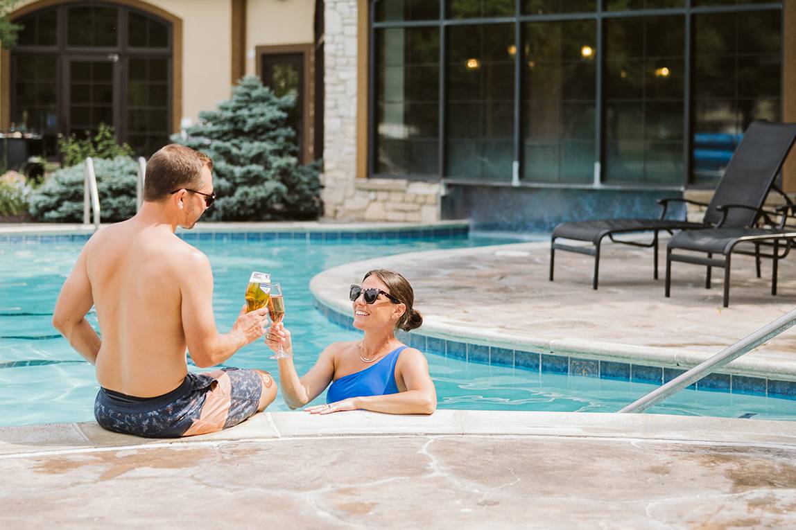 Couple enjoying drinks at the pool.