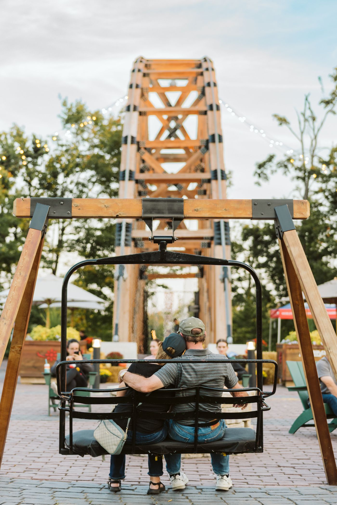 couple sitting on chairlift swing
