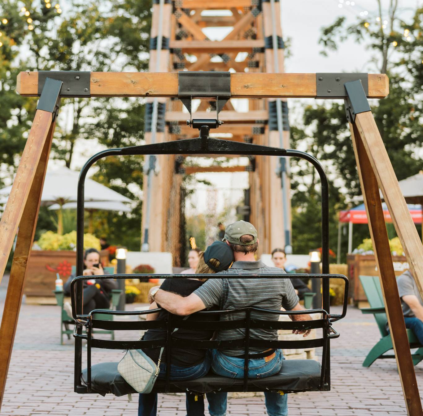 couple sitting on chairlift swing