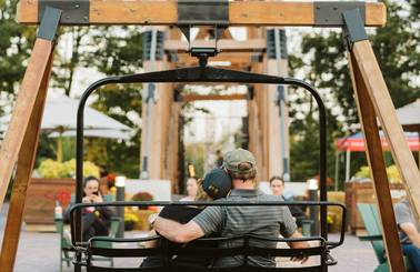 couple sitting on chairlift swing