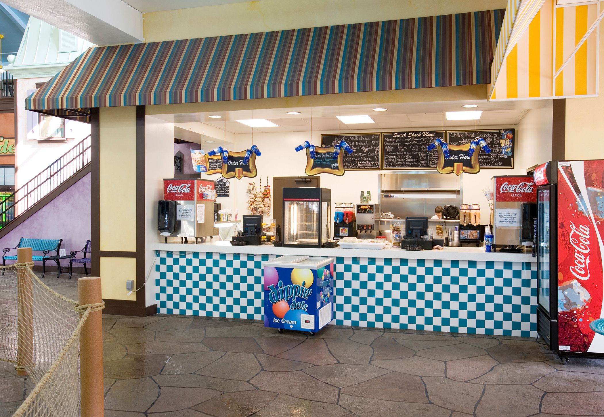 The snack shack at Avalanche Bay Waterpark with an ice cream cooler next to the counter