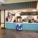 The snack shack at Avalanche Bay Waterpark with an ice cream cooler next to the counter