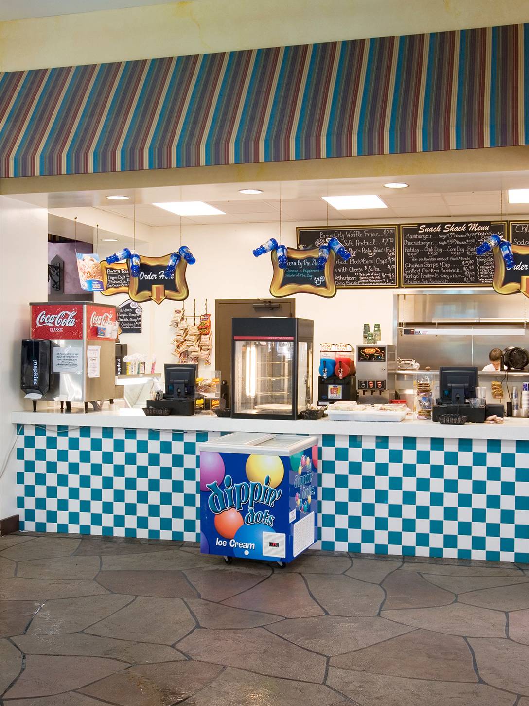 The snack shack at Avalanche Bay Waterpark with an ice cream cooler next to the counter