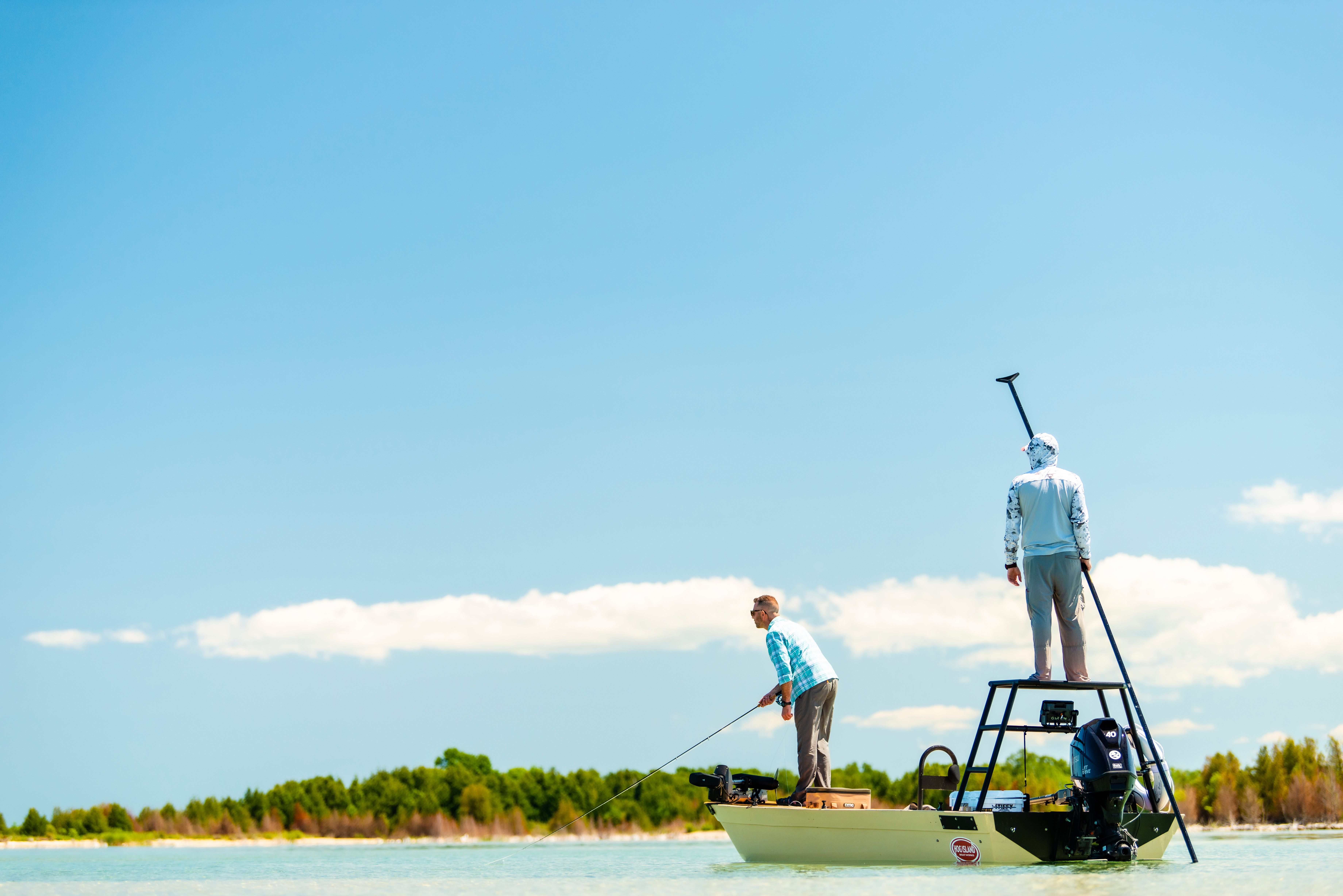 Guys standing on a boat fishing in Sturgeon Bay.