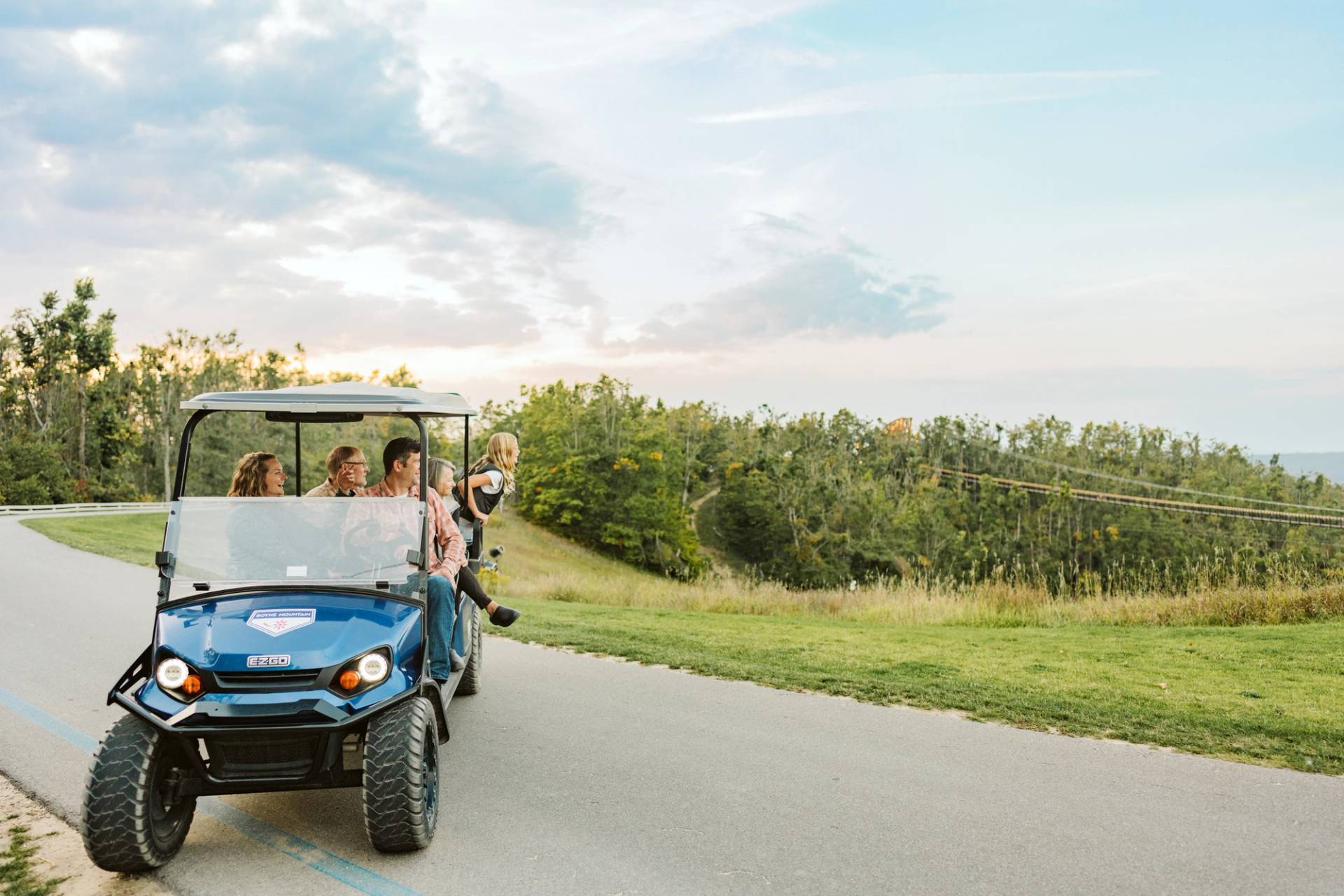 family on scenic cart by skybridge 
