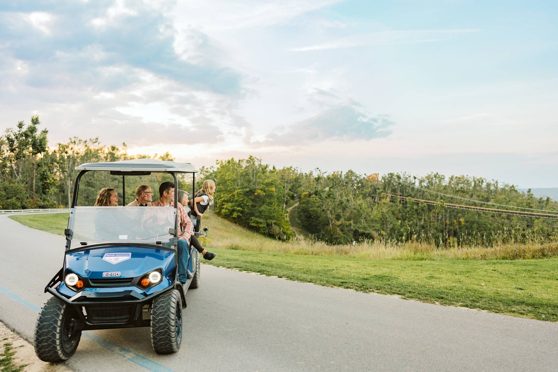 family on scenic cart by skybridge