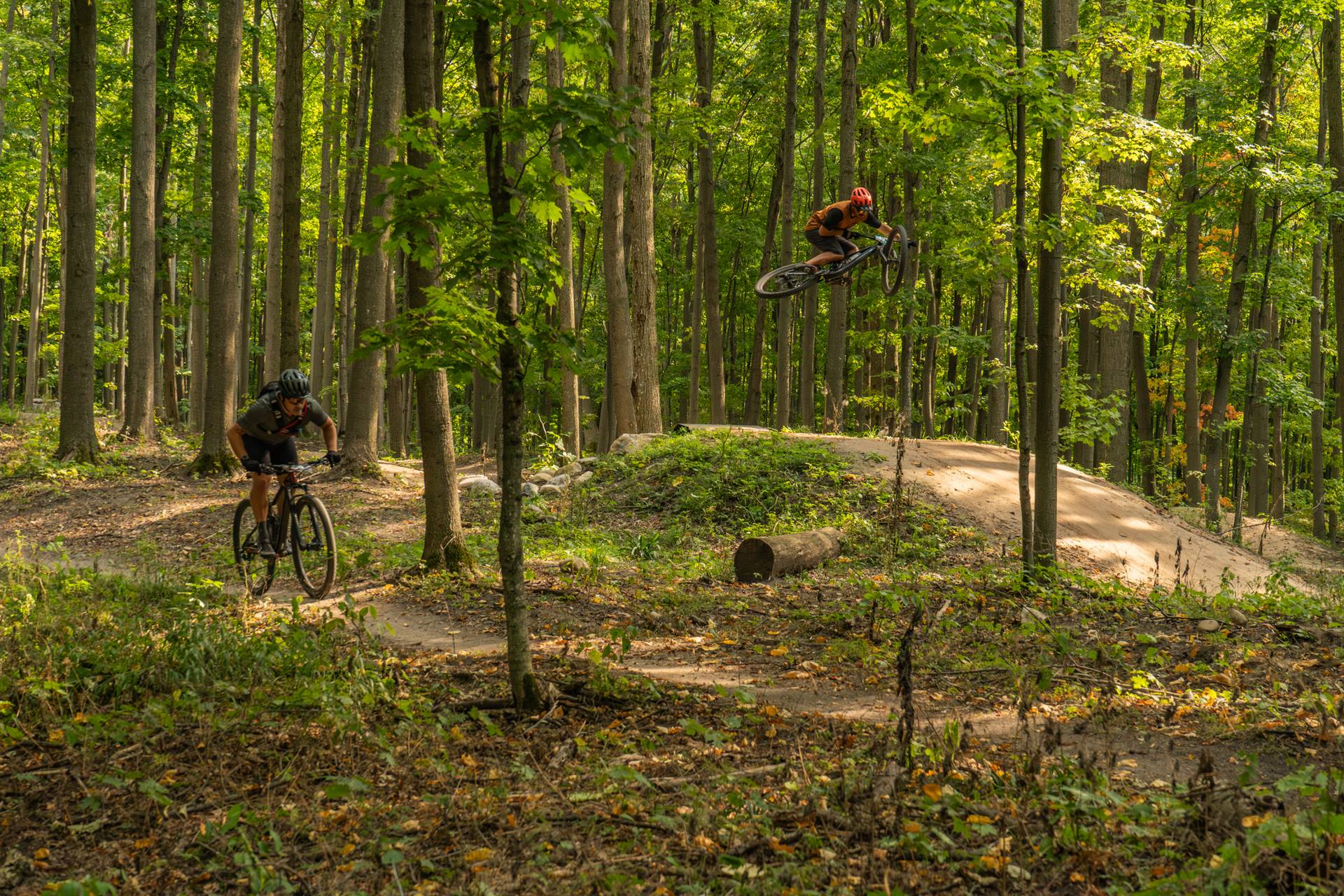 Man riding on bike on the paved trail giving a piece sign.