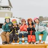 Group of young kids on picnic table eating waffles