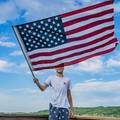 waving the American flag on Deer Lake